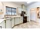 Efficient kitchen with light cabinets, black appliances, and tile floors at 17200 W Bell Rd # 1740, Surprise, AZ 85374