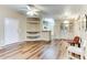 Bright living room with wood-look floors and built-in shelving at 17200 W Bell Rd # 1740, Surprise, AZ 85374
