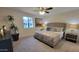 Spacious bedroom with carpeted floor, ceiling fan, and large bed at 2064 S Farnsworth Dr # 18, Mesa, AZ 85209