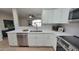 Updated kitchen featuring white cabinets, stainless steel appliances, and a breakfast bar at 2064 S Farnsworth Dr # 18, Mesa, AZ 85209