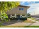 Tan two-story townhome with front yard landscaping and walkway at 2449 W Missouri Ave, Phoenix, AZ 85015
