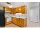 View of kitchen with wood cabinets, stove, and sink at 2449 W Missouri Ave, Phoenix, AZ 85015