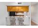 Bright kitchen features wood cabinets and a breakfast bar at 2449 W Missouri Ave, Phoenix, AZ 85015