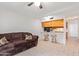 Living room with brown couch and kitchen bar at 2449 W Missouri Ave, Phoenix, AZ 85015