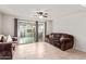 Living room with brown couches and sliding glass door to patio at 2449 W Missouri Ave, Phoenix, AZ 85015