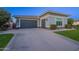 Two-car garage with gray doors and a spacious driveway at 2526 E Ravenswood Dr, Gilbert, AZ 85298