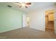 Bedroom with mint accent wall, ceiling fan and closet at 2665 W Goldmine Mountain Dr, San Tan Valley, AZ 85144