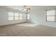 Spacious bedroom with ceiling fan and large windows at 2665 W Goldmine Mountain Dr, San Tan Valley, AZ 85144