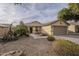One-story house with desert landscaping, two-car garage, and walkway at 2665 W Goldmine Mountain Dr, San Tan Valley, AZ 85144