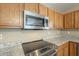 Stainless steel stove and microwave in kitchen at 2665 W Goldmine Mountain Dr, San Tan Valley, AZ 85144