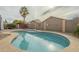 Relaxing kidney-shaped pool with concrete decking at 2665 W Goldmine Mountain Dr, San Tan Valley, AZ 85144