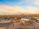 Aerial view of a beautiful home with desert landscape and mountain views at sunset at 29441 N 64Th St, Cave Creek, AZ 85331
