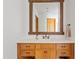 Bathroom with wood vanity, quartz countertop, and large mirror at 29441 N 64Th St, Cave Creek, AZ 85331