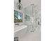 Elegant bathroom with soaking tub, glass shower, and modern lighting at 29441 N 64Th St, Cave Creek, AZ 85331