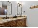 Double vanity bathroom with granite countertop and wood cabinets at 29441 N 64Th St, Cave Creek, AZ 85331