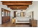 Main bedroom with wood beams and hardwood floors at 29441 N 64Th St, Cave Creek, AZ 85331