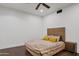 Bedroom with a bed, nightstand, ceiling fan, and wood floors at 29441 N 64Th St, Cave Creek, AZ 85331