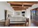 Main bedroom with wood beams, fireplace, and hardwood floors at 29441 N 64Th St, Cave Creek, AZ 85331