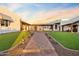 Landscaped courtyard with a fountain, brick walkway, and lush green lawn at 29441 N 64Th St, Cave Creek, AZ 85331