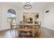 Bright dining room with large wooden table and view into the kitchen at 29441 N 64Th St, Cave Creek, AZ 85331