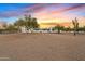 Desert landscape showcasing a contemporary Southwestern home at sunset at 29441 N 64Th St, Cave Creek, AZ 85331