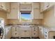 Laundry room with farmhouse sink and large window at 29441 N 64Th St, Cave Creek, AZ 85331
