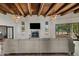 Living room with sectional sofa, fireplace, and wood beams at 29441 N 64Th St, Cave Creek, AZ 85331