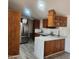 Kitchen features wood cabinets, stainless steel appliances, and an island at 30188 N Gary Rd, Queen Creek, AZ 85142
