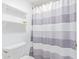 Clean bathroom with a toilet, shower, and striped shower curtain at 4200 N Miller Rd # 309, Scottsdale, AZ 85251