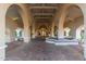 Elegant community entrance with arched walkways, fountain, and brick pavers at 4200 N Miller Rd # 309, Scottsdale, AZ 85251