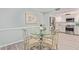 Bright dining area with glass table and four chairs, adjacent to kitchen at 4200 N Miller Rd # 309, Scottsdale, AZ 85251