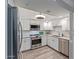 Updated kitchen featuring white cabinets and stainless steel appliances at 4200 N Miller Rd # 309, Scottsdale, AZ 85251