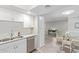 White kitchen cabinets, granite counters, and view into dining area at 4200 N Miller Rd # 309, Scottsdale, AZ 85251