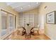 Charming dining area with glass table, built in shelving and access to the outdoors at 4531 E Quartz Mountain Rd, Paradise Valley, AZ 85253