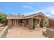 Back patio with tile flooring, covered structure, and lush landscaping at 4531 E Quartz Mountain Rd, Paradise Valley, AZ 85253
