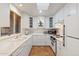 Bright eat-in kitchen, features white cabinetry, tile flooring, and modern appliances at 4531 E Quartz Mountain Rd, Paradise Valley, AZ 85253
