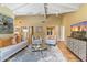 Spacious living room with vaulted ceilings, comfortable seating, and a large TV at 4531 E Quartz Mountain Rd, Paradise Valley, AZ 85253