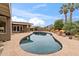 Kidney shaped pool with flagstone decking and mountain backdrop at 4531 E Quartz Mountain Rd, Paradise Valley, AZ 85253