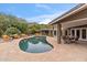 Relaxing kidney shaped pool with patio furniture and mountain views at 4531 E Quartz Mountain Rd, Paradise Valley, AZ 85253