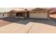 Front view of a ranch house with a driveway and a two-car garage at 5109 E Farmdale Ave, Mesa, AZ 85206