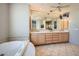 Bathroom with double vanity, soaking tub and a large mirror at 8300 E Dixileta Dr # 281, Scottsdale, AZ 85266