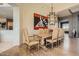 Elegant dining room features a rustic wood table, modern chandelier, and hardwood floors at 8300 E Dixileta Dr # 281, Scottsdale, AZ 85266