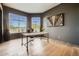 Bright home office with large windows, wood desk, and hardwood floors at 8300 E Dixileta Dr # 281, Scottsdale, AZ 85266