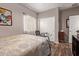 Bedroom with wood-look flooring and a glass-top desk at 10746 W Desert Elm Ln, Peoria, AZ 85383