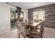 Bright dining area with wood-look wall and sliding door access to the outdoors at 10746 W Desert Elm Ln, Peoria, AZ 85383