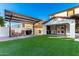 Backyard with covered patio, artificial turf, and grill at 19641 E Emperor Blvd, Queen Creek, AZ 85142