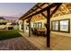 Pergola-covered patio with dining table and string lights at 19641 E Emperor Blvd, Queen Creek, AZ 85142