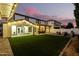 Large backyard with pergola, grassy area, and patio at 19641 E Emperor Blvd, Queen Creek, AZ 85142