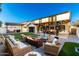 Relaxing backyard oasis with a fire pit, seating area, and pergola at 19641 E Emperor Blvd, Queen Creek, AZ 85142
