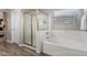 Bathroom with bathtub, shower, and wood-look tile floor at 19641 E Emperor Blvd, Queen Creek, AZ 85142